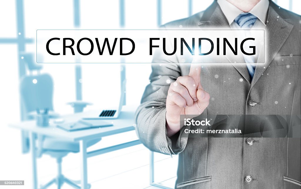 Businessman pushes virtual crowd funding button Adult Stock Photo