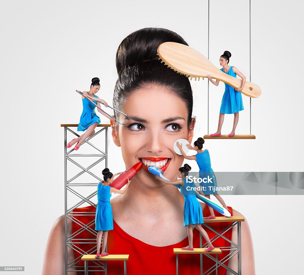 Small workers working on a beautiful woman 20-29 Years Stock Photo