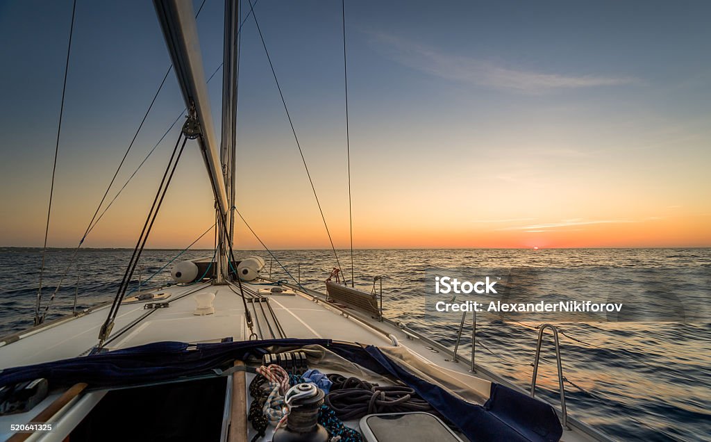 Sailing to sunset Sunset observation from the sailing boat deck Balearic Islands Stock Photo