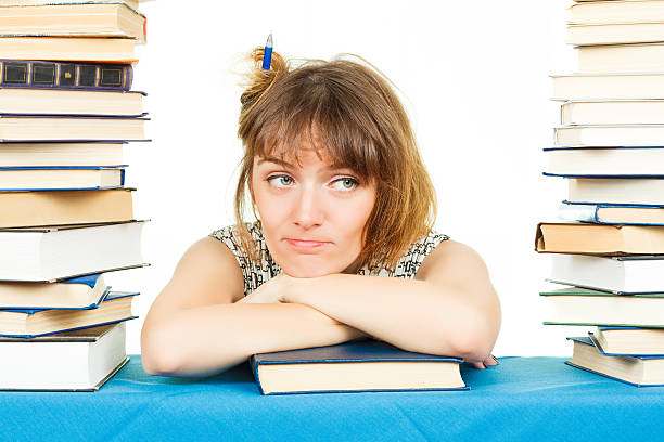 istock Girl with books isolated on white background. In the library 520641663