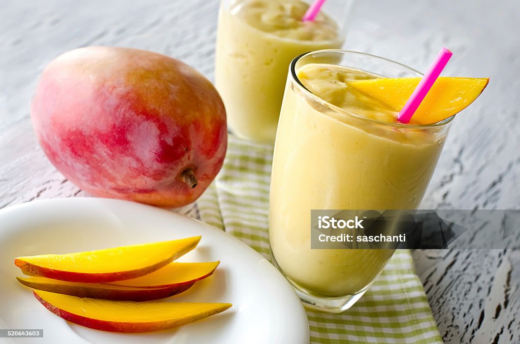 Healthy mango tropical smoothie horizontal Mango milk shake wooden background Backgrounds Stock Photo