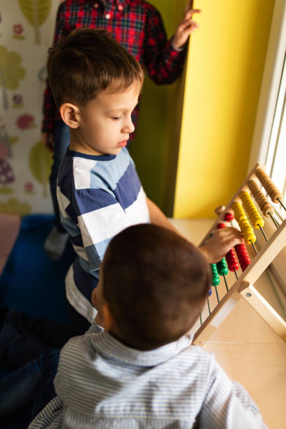istock Little boy playing with abacus at preschool. 520646064
