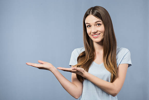 istock Cheerful smiling girl pointing aside 520646652