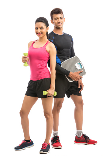 Healthy fitness people with a weight scale and dumbbell on white background.