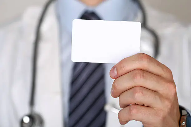 Photo of Male medicine doctor hand holding blank calling card