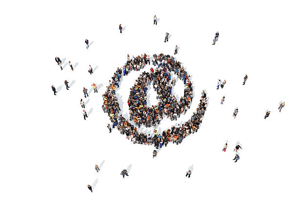 istock Group of people forming an email at symbol 520647950