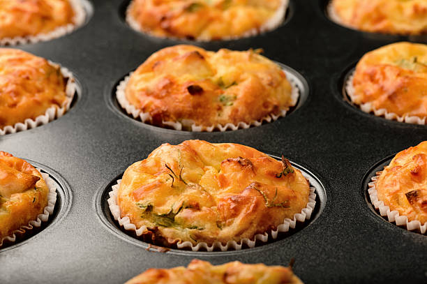istock Homemade muffins with chicken and cheese in form for baking. 520648294