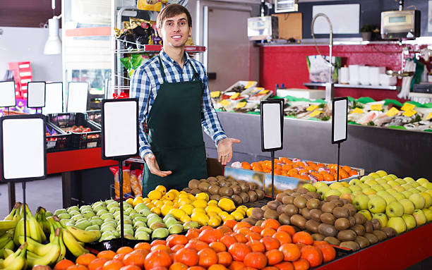 istock Grocery worker selling seasonal fruits 520648752