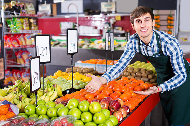 istock young man offering fruits 520648796