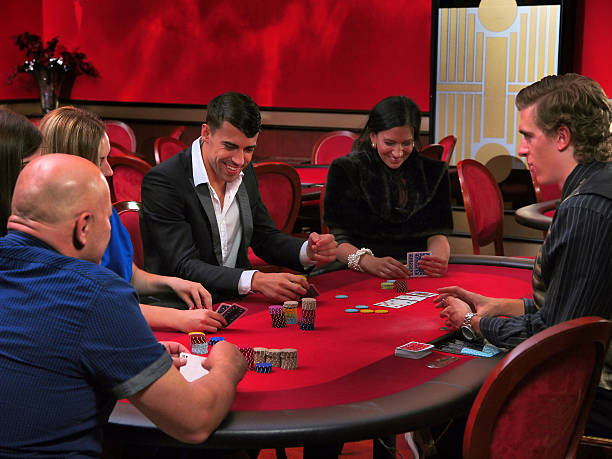 istock Young people playing poker in a casino 520649910