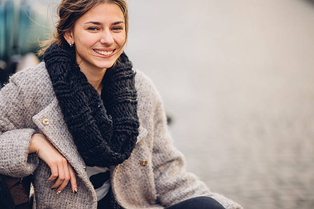 istock Pretty woman sitting on the bench and smile 520650032