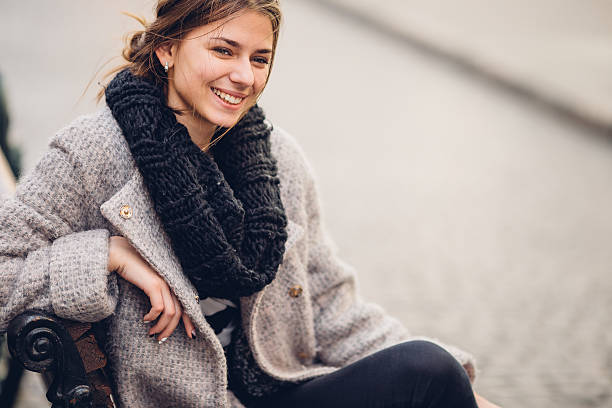 istock Pretty woman sitting on the bench and smile 520650164