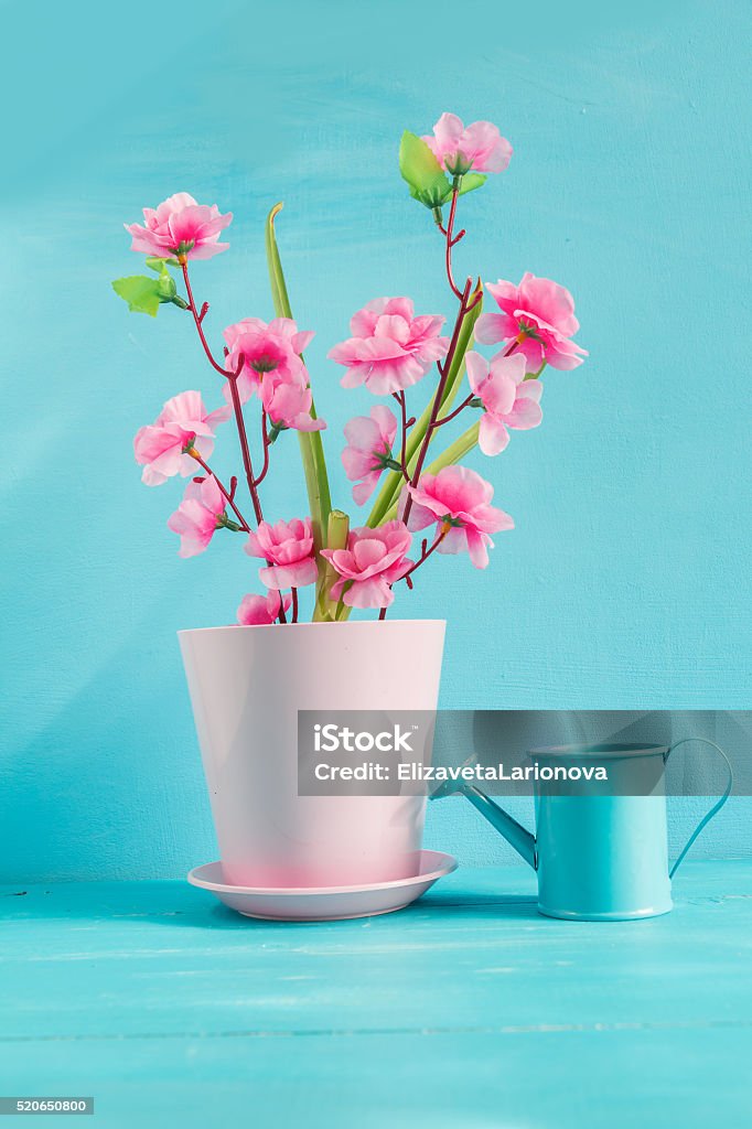 Artificial pink flower. Artificial pink flower on a blue background. Blue Background Stock Photo