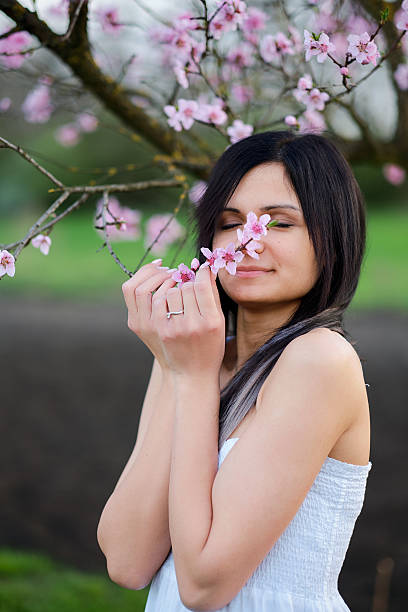 istock Young woman portrait blossom tree 520651410