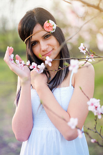istock Cute young woman with blooming tree 520651744