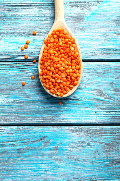 Red lentils in the wooden spoons