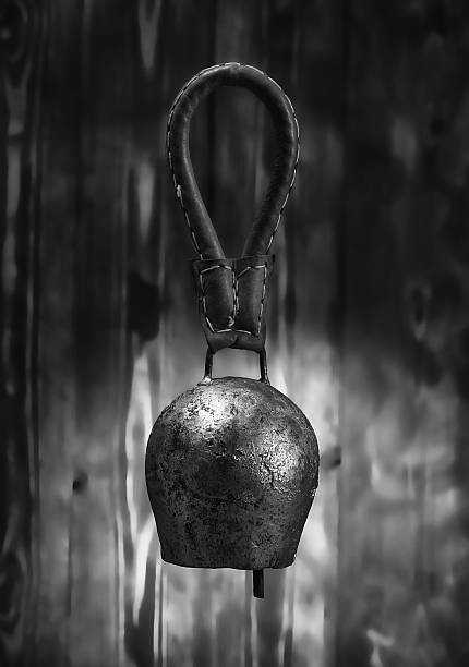Cowbell on wooden background..Black and white image.