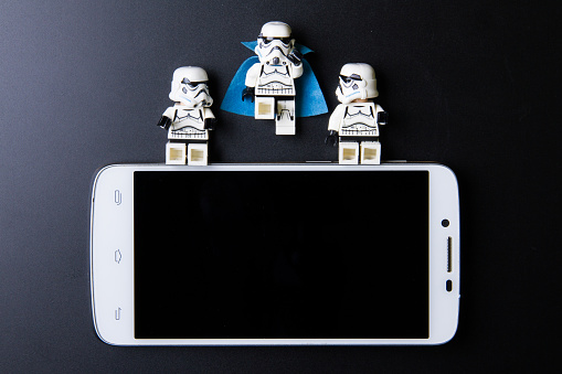 Nonthabure, Thailand - April, 05, 2016 : Lego stormtrooperSitting on the edge smartphone.The lego Star Wars mini figures from movie series.Lego is an interlocking brick system collected around the world.