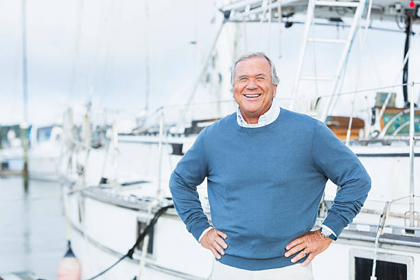 istock Senior man at marina, standing with hands on hips 520654934