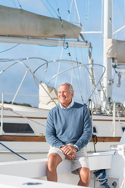 istock Senior man at boat dock sitting on yacht 520655248