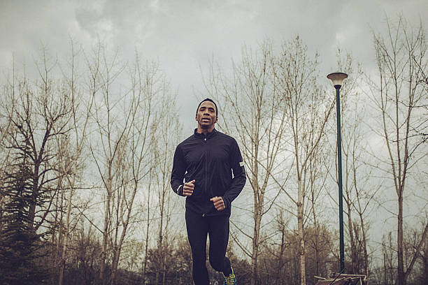 istock Front view of a young fit man running 520657200