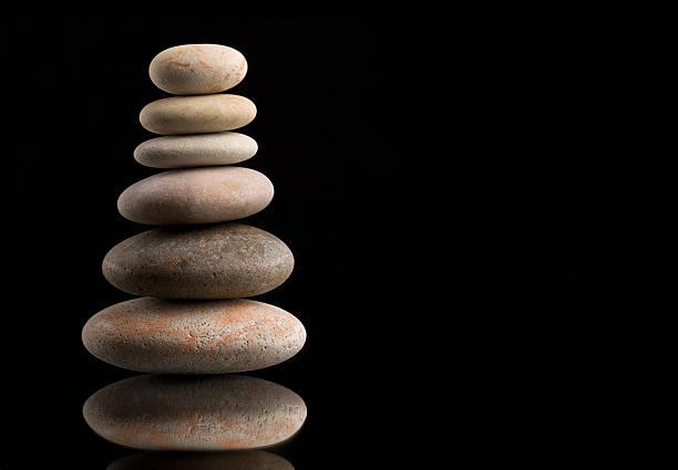 istock balancing zen stones on black 520658282