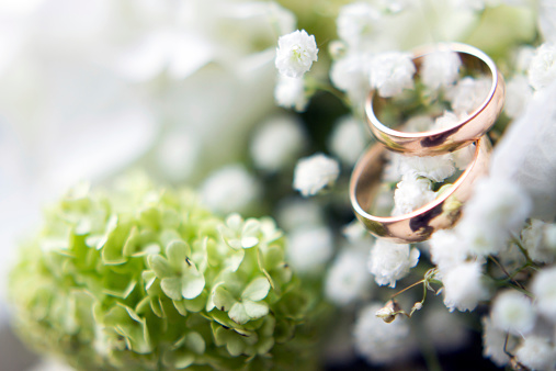 Wedding rings on bride bouquet.