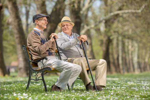 istock Two old friends talking in park 520658916