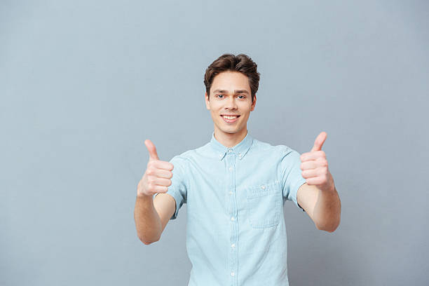 istock Smiling man showing thumbs up 520660084