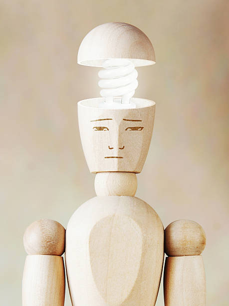 istock Glowing light bulb in the human head. Concept of genius 520660244