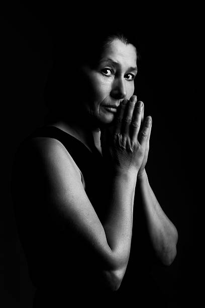 istock Woman prays on a black background 520660688