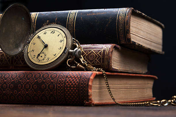 istock Old pocket watch and books with copy space 520661786