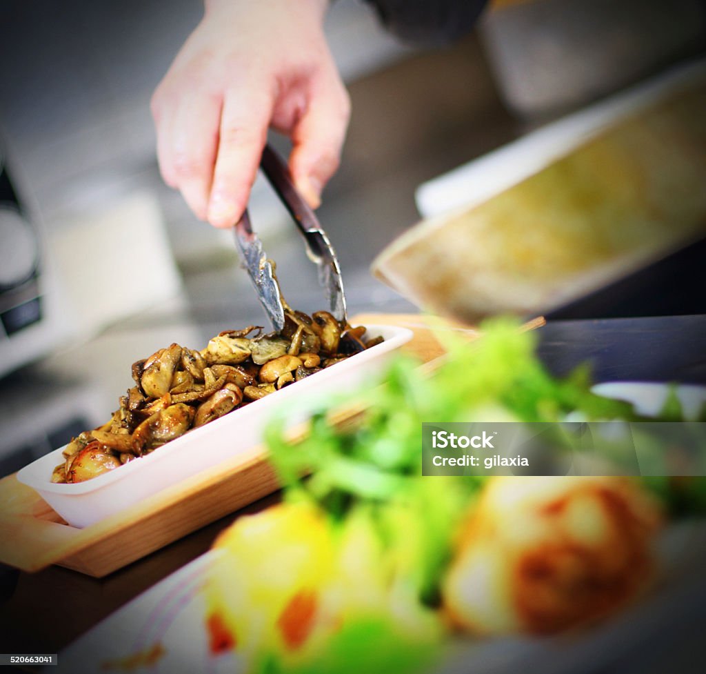 Serving food. Male chef serving side dish and lunch is ready to be eaten Adult Stock Photo
