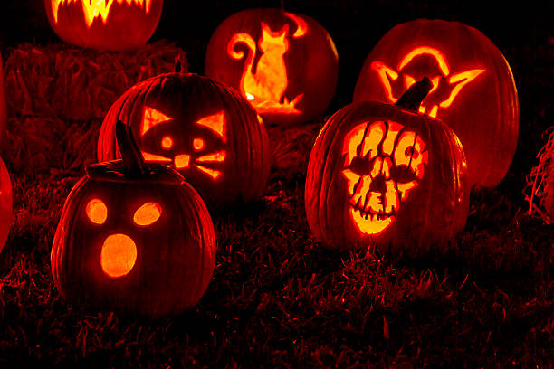 istock Lighted Halloween Pumpkins with Candles 520664429