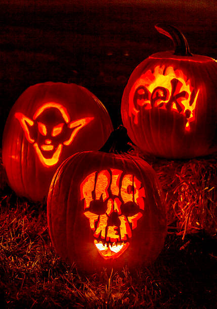 istock Lighted Halloween Pumpkins with Candles 520664439