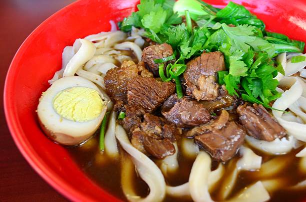 Hand cut thick noodles in soup, served with beef brisket, soy sauce egg and parsley (紅燒牛肉麵)