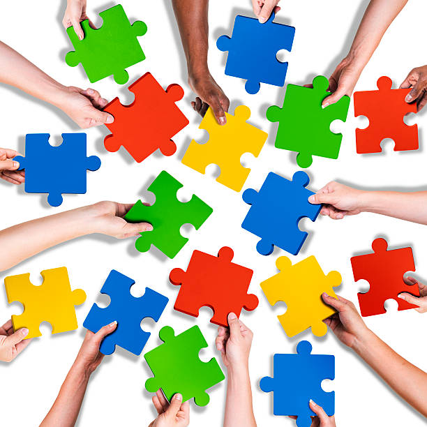 istock Group of Diverse Hands Holding Jigsaw Puzzle 520665313