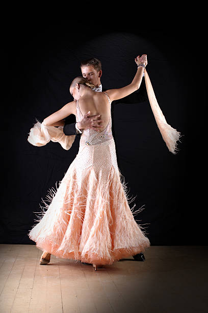 istock Latino dancers in ballroom against on black 520684673