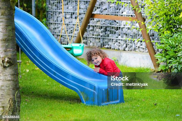 Sweet Girl In Garden Playing Stock Photo - Download Image Now - Bright, Cheerful, Child