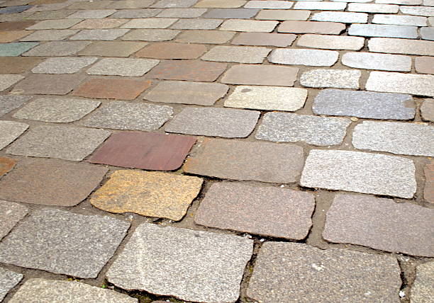 overhead close up of a cobblestone road made with different types and sizes of stones in the historic downtown district of Porto, Portugal