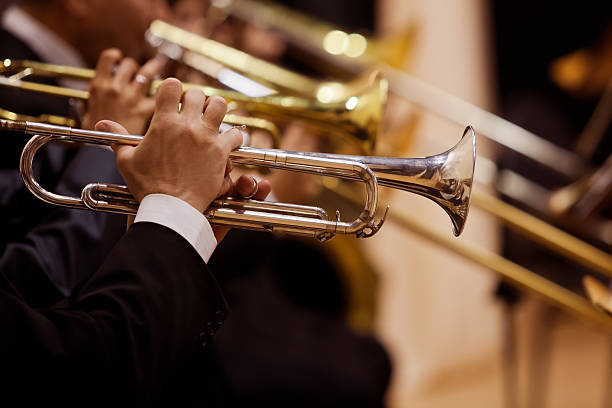 Pipes in the hands of musicians Hands of the man playing the trumpet closeup performance group stock pictures, royalty-free photos & images