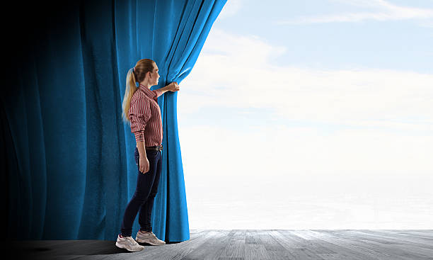 istock Girl opening curtain 520691617