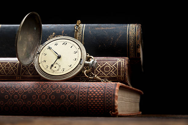 Old pocket watch and books with copy space