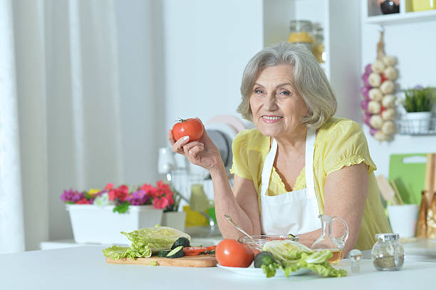 istock Senior woman cooking in kitchen 520700356