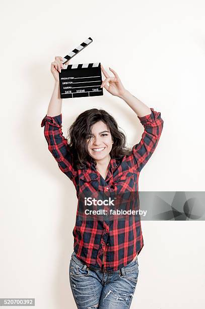 Smiling Brunette Actress With Movie Clapper Board Up Stock Photo - Download Image Now