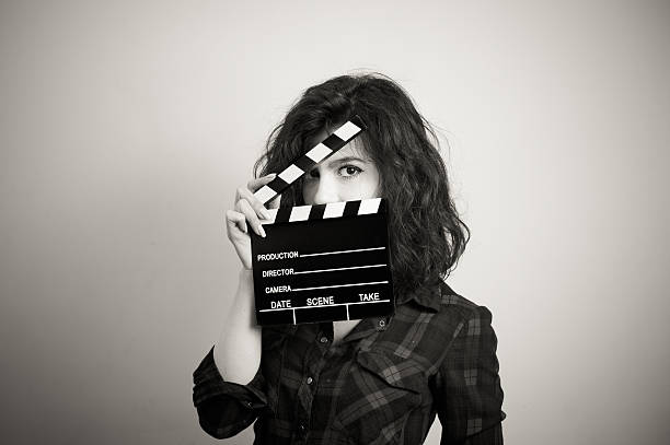 Woman actress eyes portrait behind movie clapper board Woman actress eyes portrait behind movie clapper board vintage black and white audition photos stock pictures, royalty-free photos & images