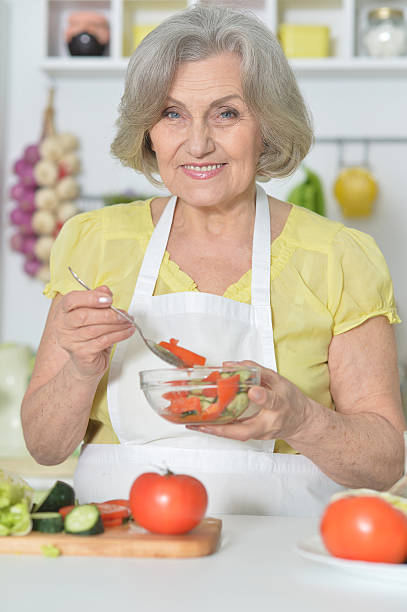 istock Senior woman cooking in kitchen 520700570