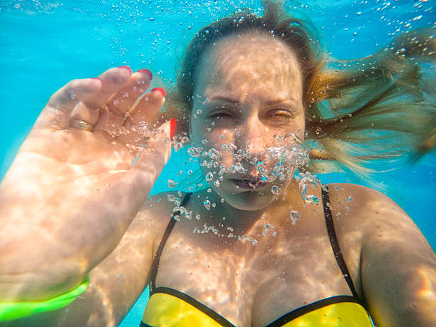 istock Girl taking undrewater selfie 520701698