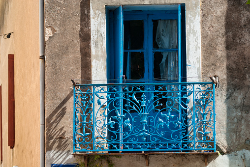 Montagnac, France - July 16, 2007: Montagnac (Languedoc-Roussillon, France):  blue window and balcony