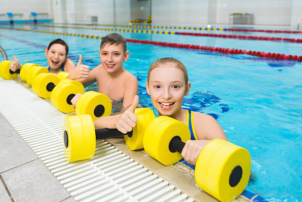 istock Happy and smiling group of children doing exercises in a 520703300